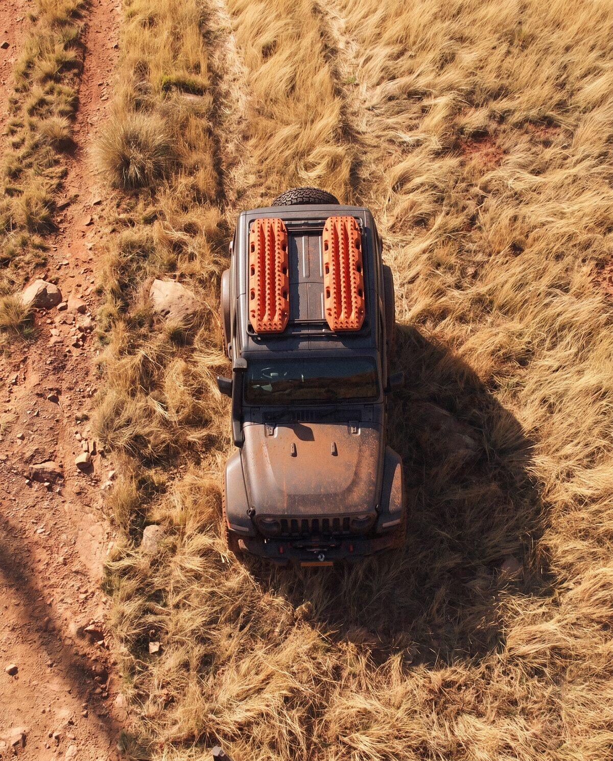 Top down aerial of a 4WD carrying recovery boards on a two wheel track